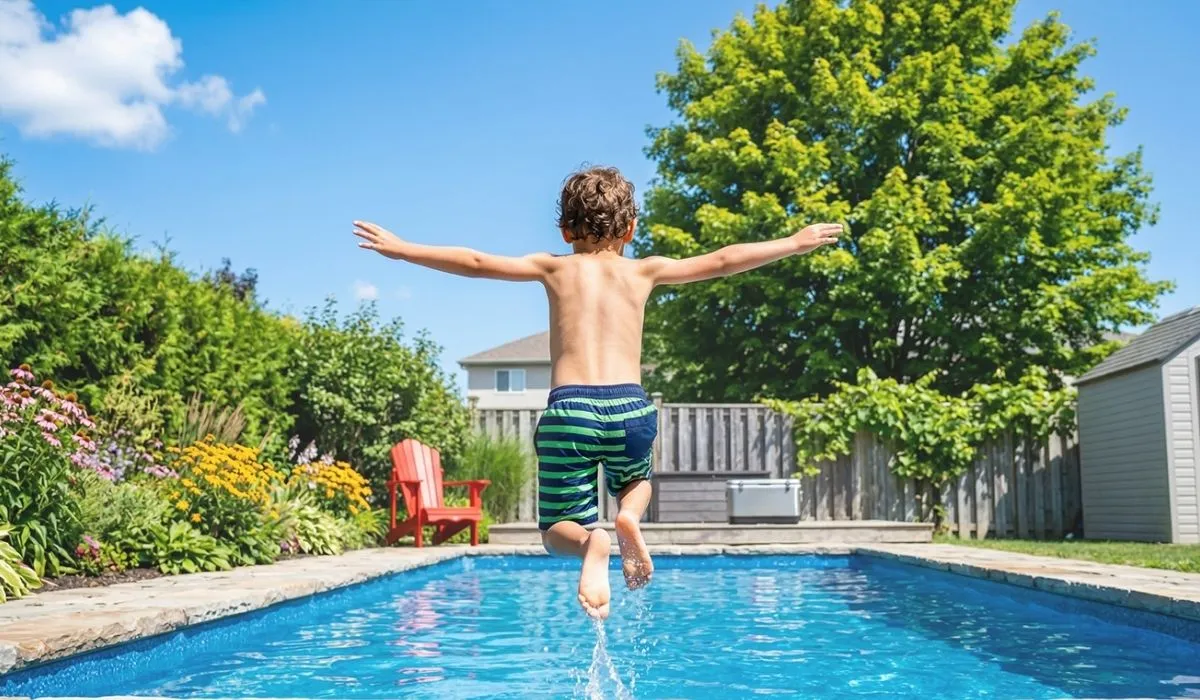 Boy jumping into a custom pool — Aquascapes Waterloo Region
