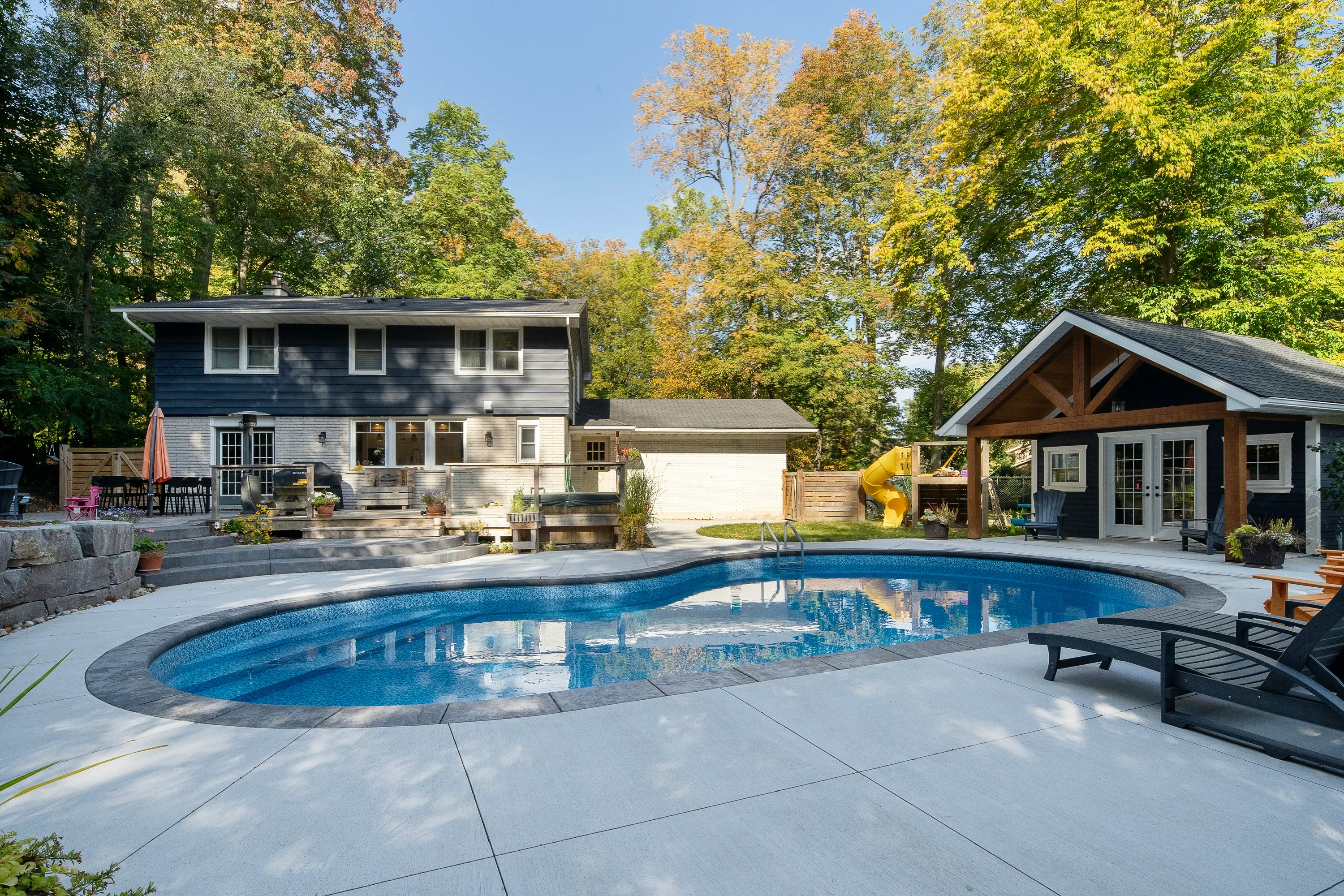 Celebrity — custom angled stairs, separate hot tub, retaining walls, stone coping