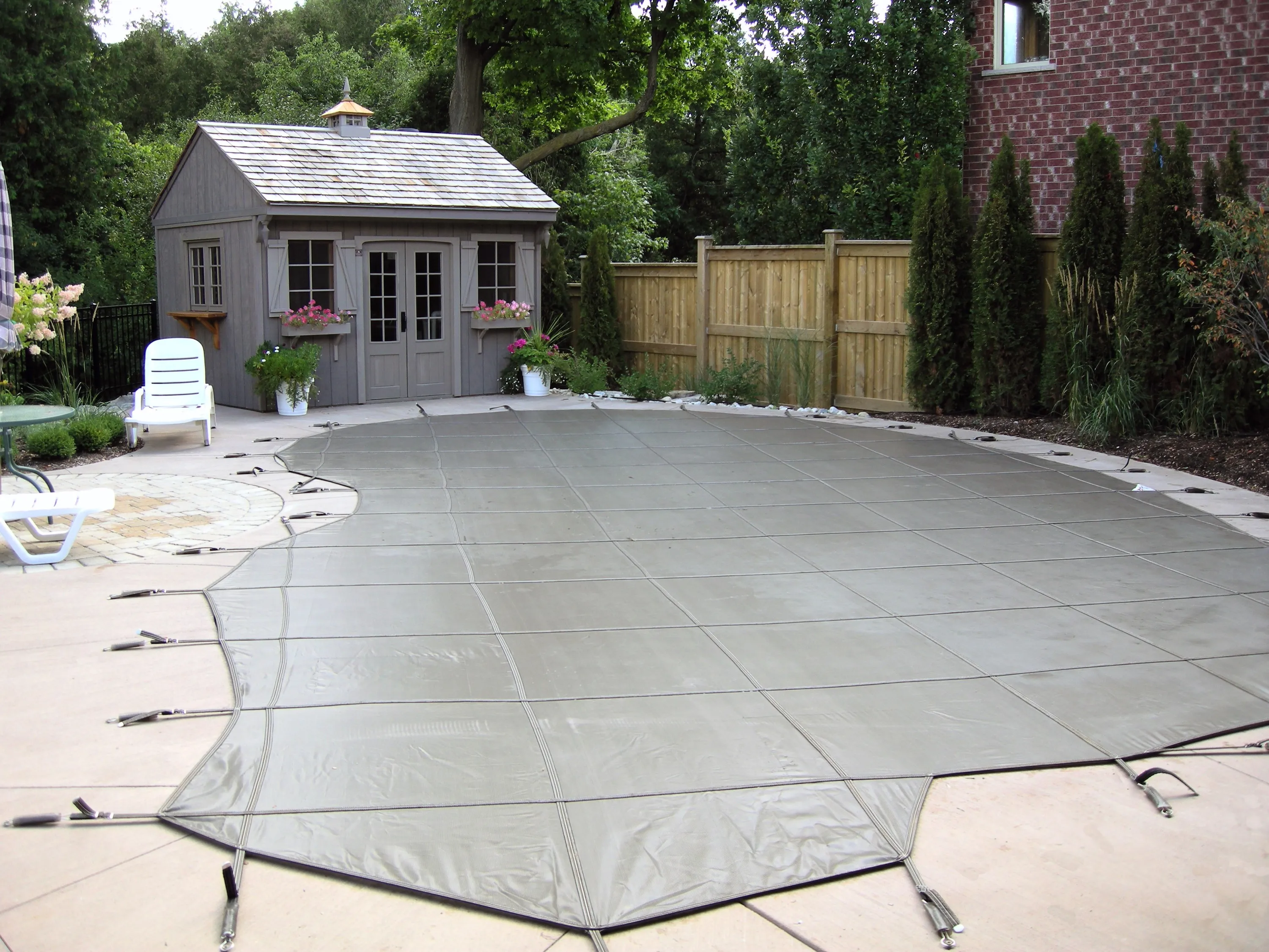 Custom-fit safety cover on a Guelph pool