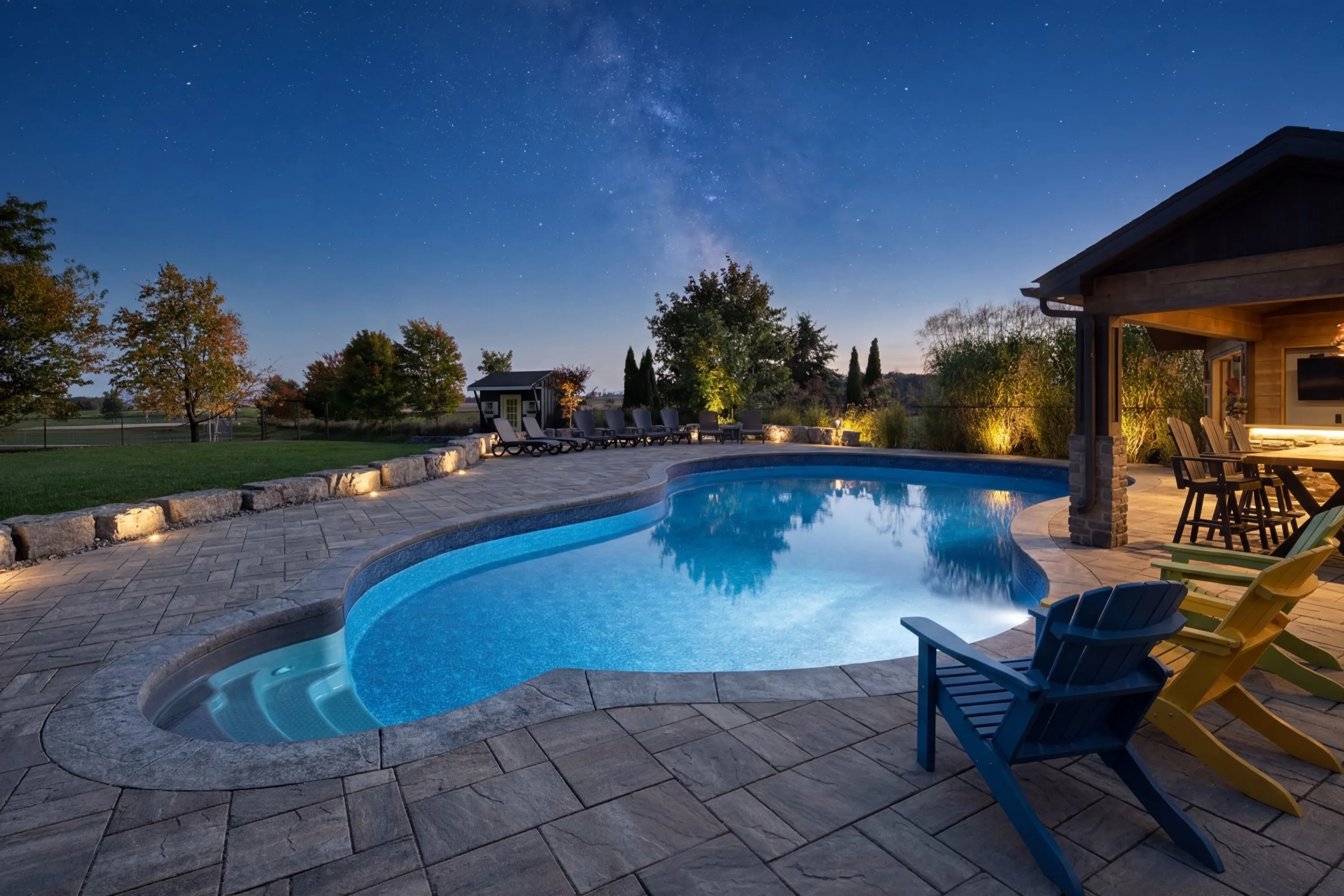 Illuminated custom pool at night — Aquascapes Waterloo Region